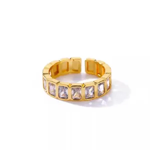 Detailed view of gold-plated open ring with rectangular clear cubic zirconia stones
