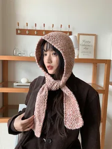 Close-up view of a cozy pink and white knit hood scarf combo for winter warmth and style