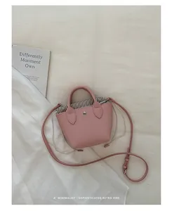 Vue détaillée du mini sac seau rose minimaliste avec doublure rayée et design rétro