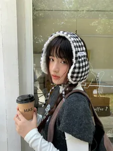Close-up of Japanese retro checkered plush earmuffs worn by a model in winter