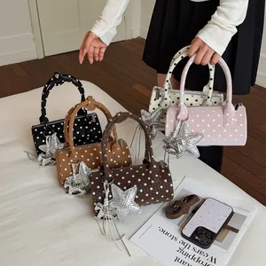 Collection of colorful polka dot cylinder handbags with star charms and tassels.