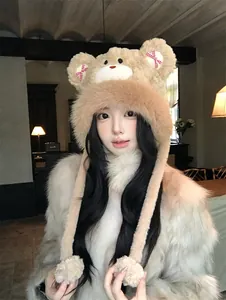 Detailed view of sweet plush bear hat with bows worn by a model in cozy room.