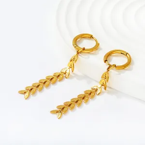 Macro view of gold-plated stainless steel leaf tassel earrings with detailed wheat-ear pattern