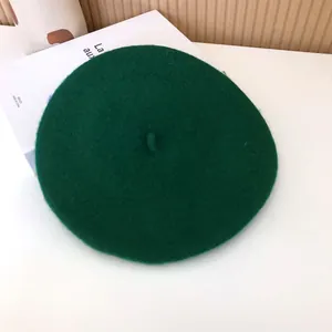 Top view of a classic dark green wool felt beret for women's autumn winter fashion