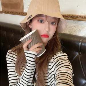Stylish beige wrinkled bucket hat for women showing textured fabric and summer vibe