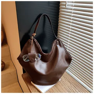 Large capacity slouchy hobo bag in vintage brown leather finish with a unique glasses charm