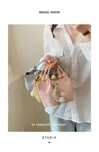 Close-up detail of stylish pastel bucket bags with elegant pearl and tulip charms