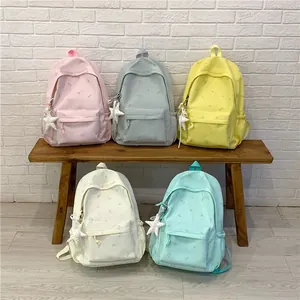 Fresh pastel student backpacks in five colors with star patterns and plush pendants.