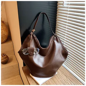 Dark brown oversized faux leather hobo tote bag featuring a unique glasses holder accessory