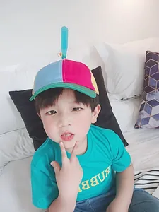 Detailed view of kids' colorful patchwork baseball cap with a spinning propeller