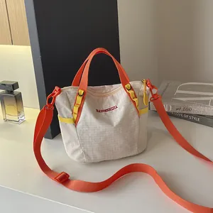 Stylish white grid canvas tote bag with vibrant orange straps for fitness and daily use