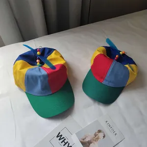 Colorful kids baseball caps with spinning propeller and vibrant color-block patchwork design