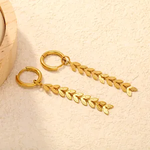 Macro view of gold-plated stainless steel leaf tassel earrings with detailed wheat ear texture