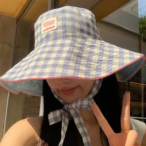 Wide-brimmed checkered sun hat with tie strap for summer beach outdoor