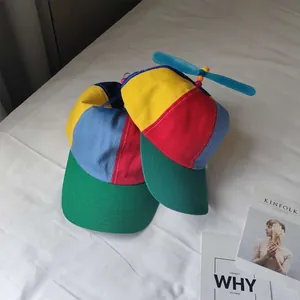 Detailed view of colorful kids patchwork baseball cap featuring a blue rotating propeller