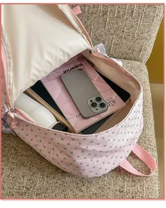 Detailed view of the spacious interior of a pink star-patterned school backpack