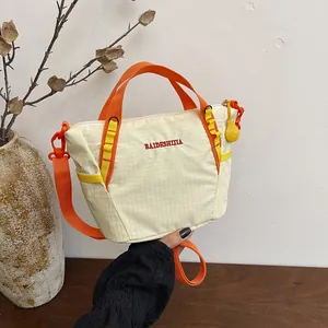 Casual cream grid canvas crossbody bag with vibrant orange straps and embroidery
