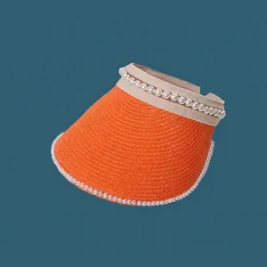 Detailed view of a vibrant orange straw sun visor featuring elegant white pearl decorations.