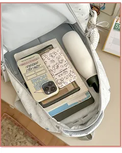 Detail shot showing large interior capacity of light gray star pattern casual school bag