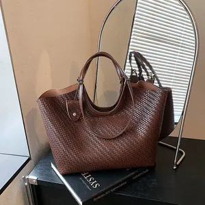 Close-up detail of a stylish brown woven tote bag displayed in a modern home interior