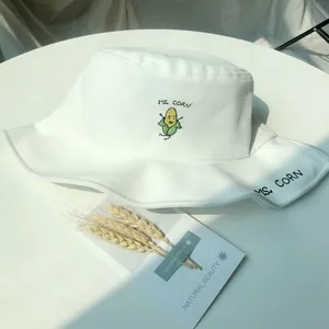 Close-up of white bucket hat featuring cute embroidered corn and MS. CORN text details.