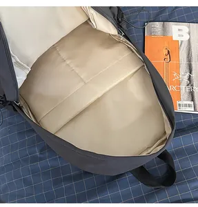 Detailed macro view of the spacious interior and laptop sleeve of the grey backpack