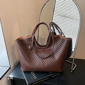 Detailed view of dark brown woven tote bag showing its rich texture and large capacity