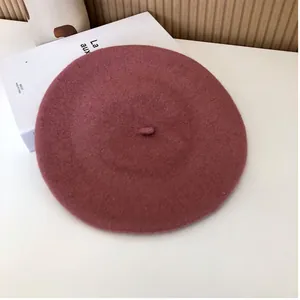 Retro Japanese style mauve pink wool beret hat shown on a minimalist white prop background
