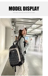Asian model wearing a stylish Korean style large capacity black and grey commuter backpack.