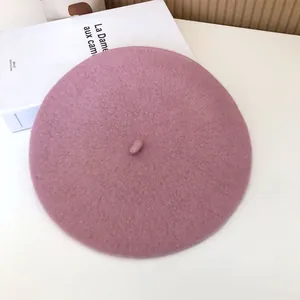 Close-up of a mauve wool beret featuring soft felt texture and classic stem detail.