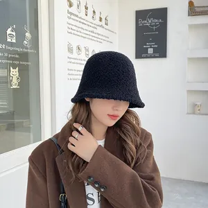 Warm black lambswool bucket hat for women, perfect for winter street style fashion outfits