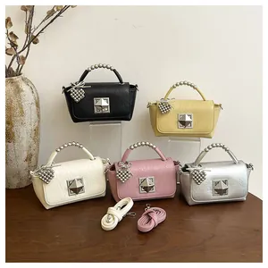 Collection of small square handbags in black, yellow, white, pink, and silver