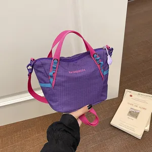 Detailed view of women's purple fitness yoga bag with contrasting pink handles