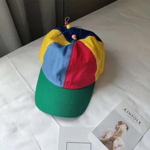 Detail view of colorful propeller baseball cap with vibrant multi-color panels