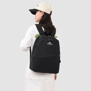 Back view of a minimalist large capacity black Japanese style school bag for sports and travel
