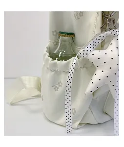 Close-up of a white floral backpack side pocket with a star pendant and polka dot ribbon
