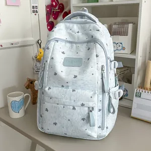Detail view of a light blue stars pattern backpack placed on a study desk with props