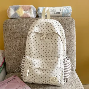 Aesthetic cream backpack featuring brown star pattern and striped side pocket details