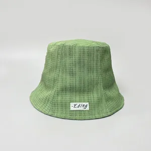 Close-up detail of a green wrinkled texture bucket hat designed for women's sun protection