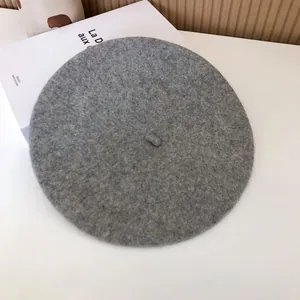Close-up showing the soft wool felt texture of a classic grey literary style beret