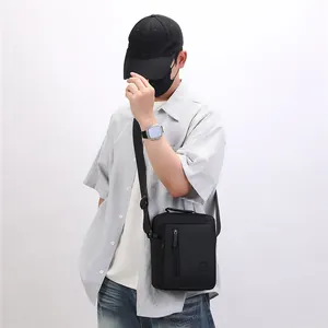 Black casual crossbody square bag for men worn by model, perfect for daily fashion