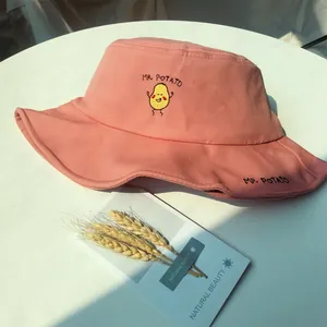 Close-up of pink bucket hat featuring cute potato embroidery and MR. POTATO text.