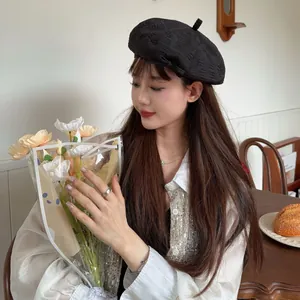 Vintage black frayed beret hat for women shown in a stylish Japanese street style fashion shoot.