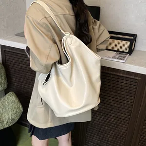 Detail shot of off-white large capacity tote bag shown on model for daily use