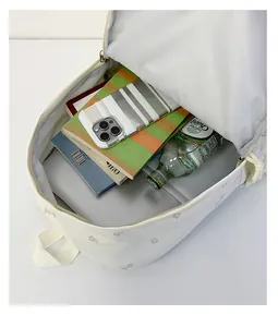Interior view of large capacity white floral backpack showing storage items