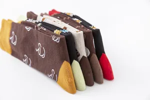 Detailed side view of folded colorful cotton mid-calf socks with beverage patterns