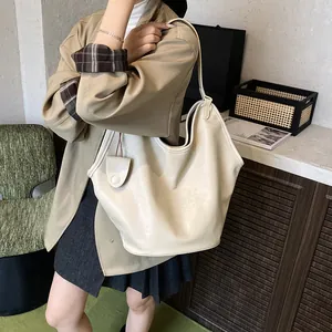 Close-up of a stylish cream-colored hobo shoulder bag showing its large capacity and soft texture