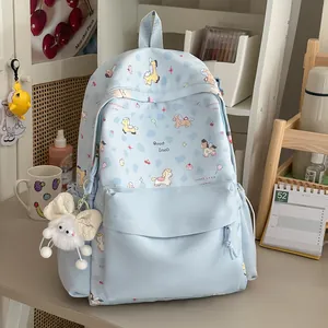 Detail of light blue backpack with sweet cartoon pony pattern and plush charm