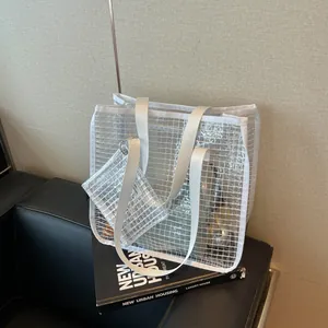 Detailed view of a white grid transparent tote bag with a matching accessory pouch