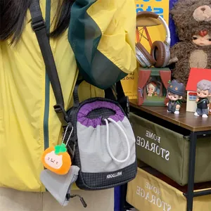 Détail d'un petit sac bandoulière pour téléphone avec un joli charme de chat en peluche